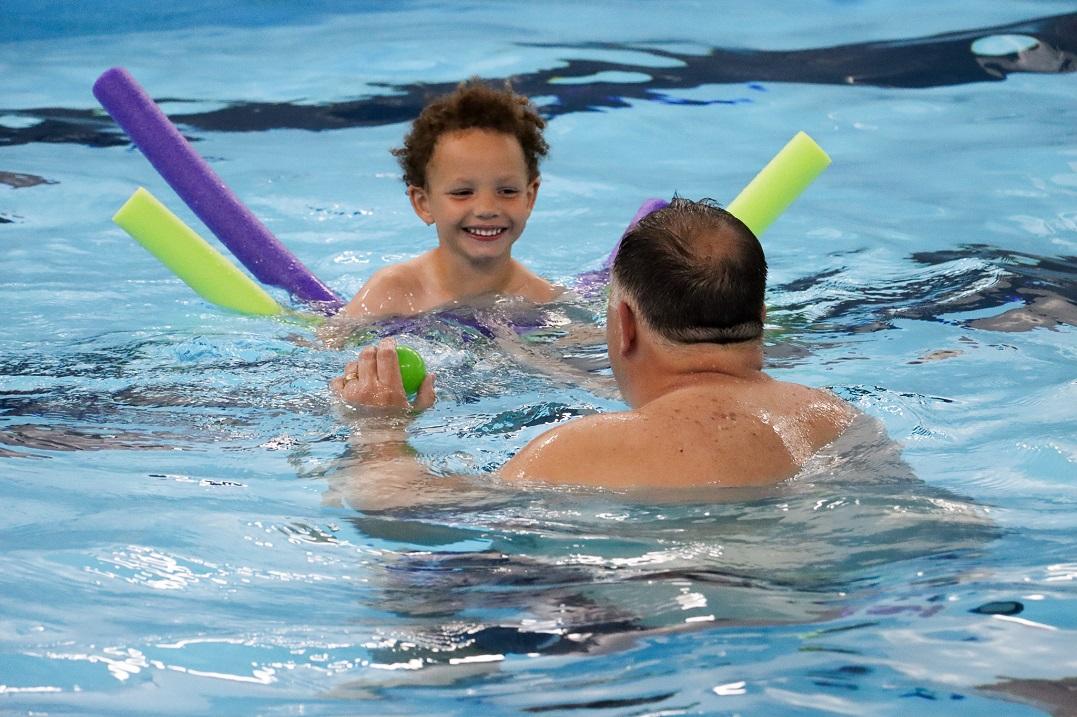 Boy getting swim lessons at ADG's World's Largest Swimming Lesson